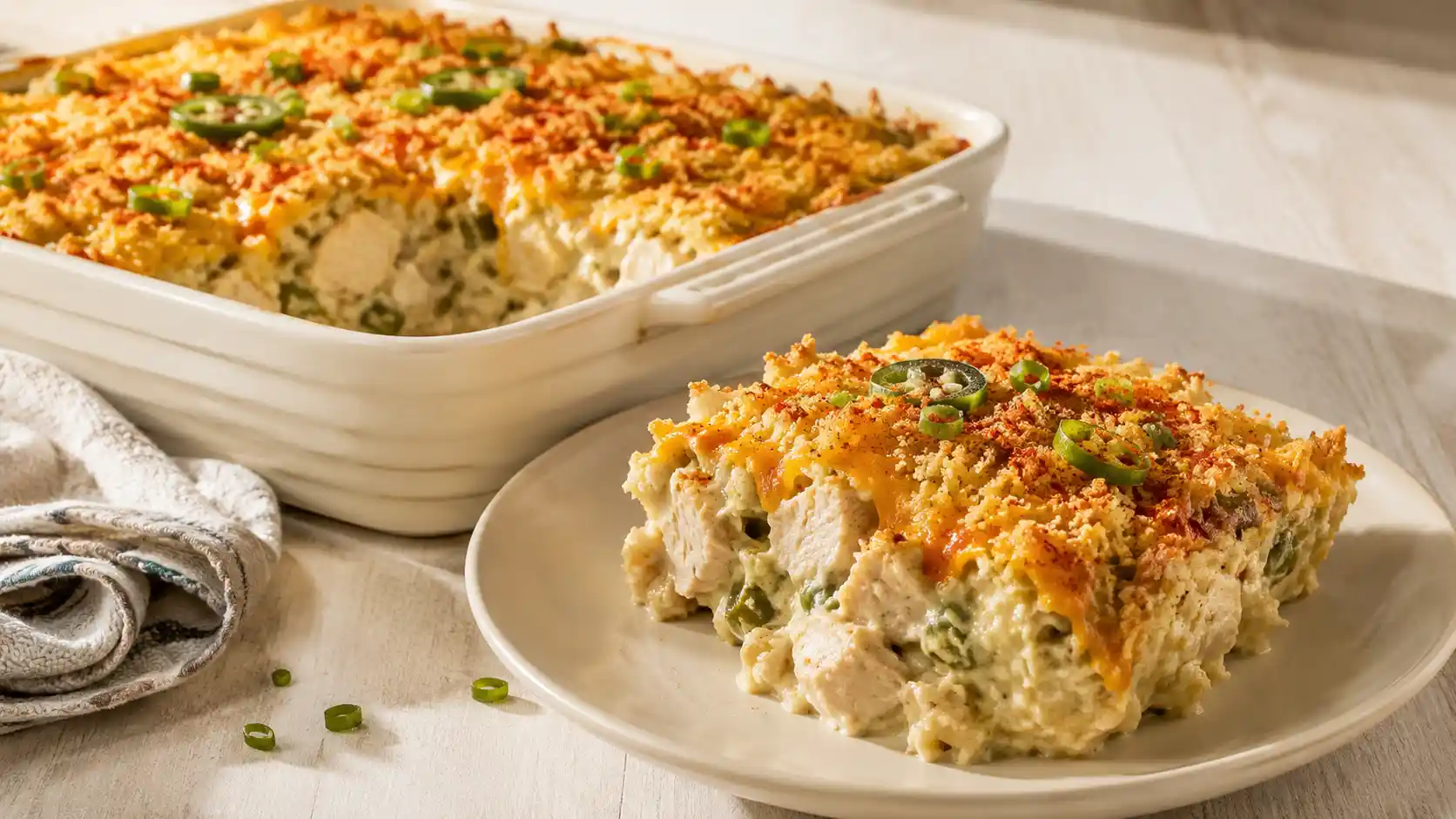 Bacon-free jalapeño popper chicken casserole with cottage cheese, cheddar, fresh jalapeños, and golden panko topping