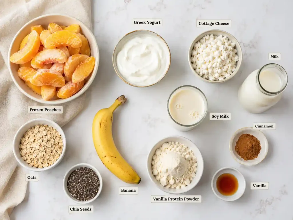 Labeled ingredients for peach protein smoothies including frozen peaches, Greek yogurt, cottage cheese, oats, chia seeds, banana, milk, soy milk, vanilla protein powder, cinnamon, and vanilla.