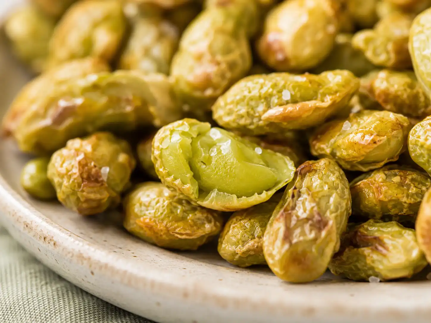 Close-up of roasted edamame with dry wrinkled surfaces and lightly browned edges