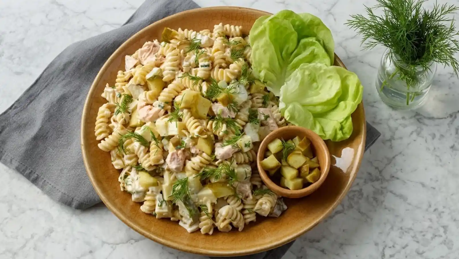 Creamy dill pickle chicken pasta salad with rotini, chicken, pickles, celery, red onion, and fresh dill